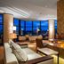 Hilton Kyiv lounge with central fire feature, city views, and floor-to-ceiling windows in Kyiv