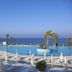 King Evelthon Beach Hotel & Resort in Paphos with ocean-view pool terrace and sun loungers
