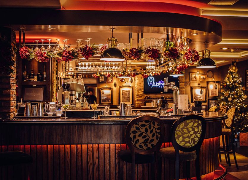 The Torrance Hotel Glasgow bar with festive decor, lit counter, and Christmas tree