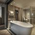 Tastoria Collection Sukhumvit Bangkok bathroom with freestanding tub and glass shower