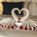 Vilanculos Beach Lodge bed with heart-shaped towel arrangement and red rose petals in Vilanculos