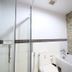 Ao Nang Beach Resort in Krabi bathroom with glass shower, bathtub, toilet and tiled accent wall