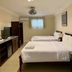 Panglao Regents Park Resort room with two single beds, TV cabinet and window in Panglao