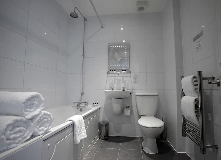 Park Central Hotel Bournemouth bathroom with shower, sink, toilet and towel rack