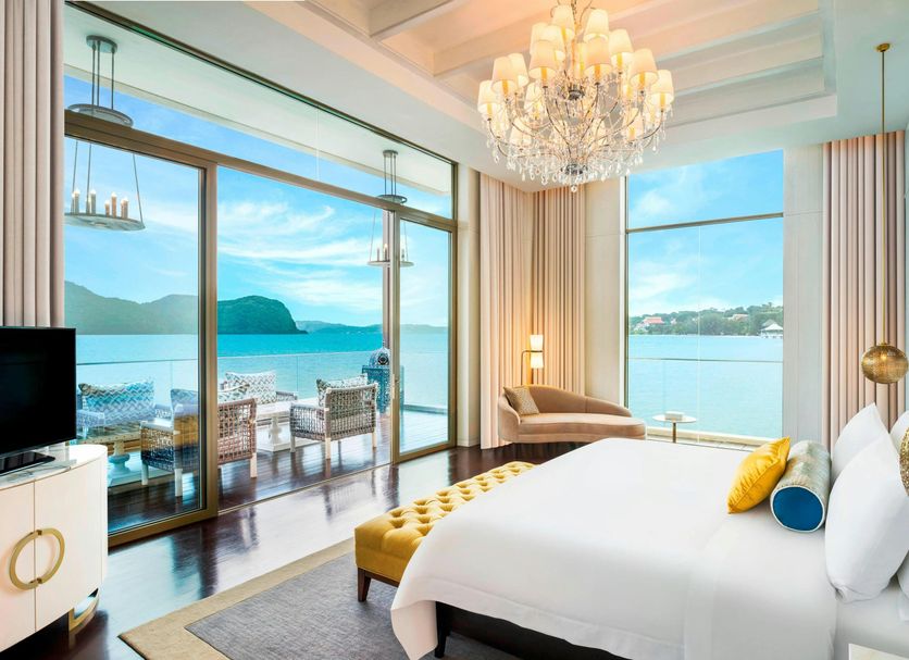 The St. Regis Langkawi bedroom with sea-view balcony and chandelier