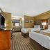 Quality Inn & Suites Westminster Seal Beach guest room with two beds and work desk in Westminster
