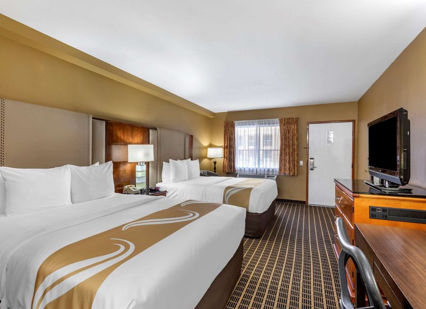 Quality Inn & Suites Westminster Seal Beach guest room with two queen beds and TV in Westminster