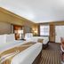 Quality Inn & Suites Westminster Seal Beach guest room with two queen beds and TV in Westminster