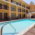 Quality Inn & Suites Westminster Seal Beach outdoor courtyard pool with lounge chairs in Westminster