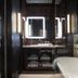 Hotel Les Bains Paris bathroom with double vanity mirrors and a freestanding soaking tub in Paris