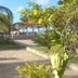 Beach Hotel Jacuma in João Pessoa with palm-lined patio, stone walkway, and oceanfront gazebo