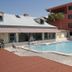 Gulf Towers Resort Motel in Indian Rocks Beach with an outdoor pool beside a red building