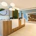 Element Ontario Rancho Cucamonga lobby with modern front desk, shelves, and pendant lights in Ontario
