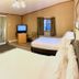 Sunwapta Falls Rocky Mountain Lodge room in Jasper with two beds, desk, TV and window