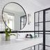 Cape Cadogan Boutique Hotel bathroom in Cape Town with round mirror, white tile, glass shower and vanity