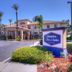 Hampton Inn & Suites Ontario exterior with palm trees and a covered entrance