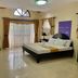 The Q Hotel Tagaytay guest room with king bed, balcony doors, desk and TV