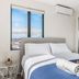 110 Hampden Apartments Hobart bedroom with queen bed, mirrored wardrobe and city view