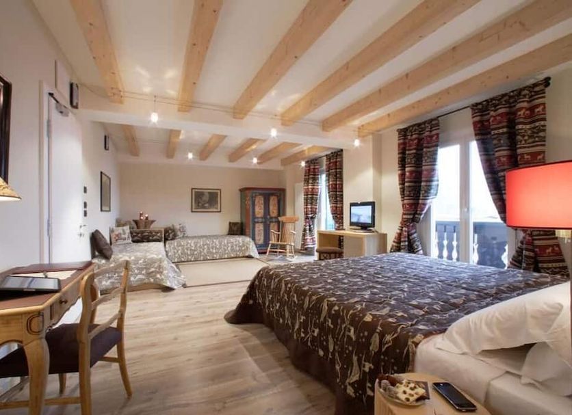 Hotel Savoia dal 1924 in San Martino di Castrozza: spacious guest room with balcony and mountain-view windows