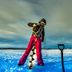Arctic Gourmet Cabin in Kiruna: person ice fishing on a snowy frozen lake under cloudy skies