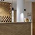 Diamond's Hotel Zakopane reception desk with decorative wood partition and pendant lights