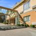 Motel 6 Surrey Bc in Surrey exterior with covered entrance and glass canopy over the driveway