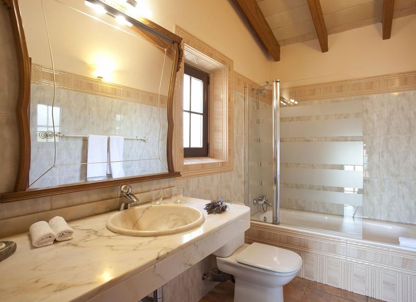 Agroturismo Es Quatre Cantons bathroom in Binissalem with marble vanity, bathtub and glass shower