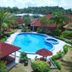 Hotel Seri Malaysia Mersing in Mersing with a tropical outdoor pool and red-roofed resort buildings
