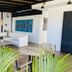 Ocean Breeze Santo Domingo lounge with white seating, tropical plants and colorful wall art