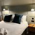 The Punch Bowl, Woodstock: double bed with white linens, dark pillows, bedside lamps and wooden tables