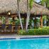 Club Wyndham Sea Gardens in Pompano Beach with a tiki bar beside a pool and palm trees