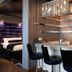 Hard Rock Hotel & Casino Biloxi lounge with bar seating and bedroom glimpse in Biloxi
