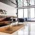 Krista Boutique Hotel Buenos Aires lounge with leather sofa, coffee tables, and floor-to-ceiling windows