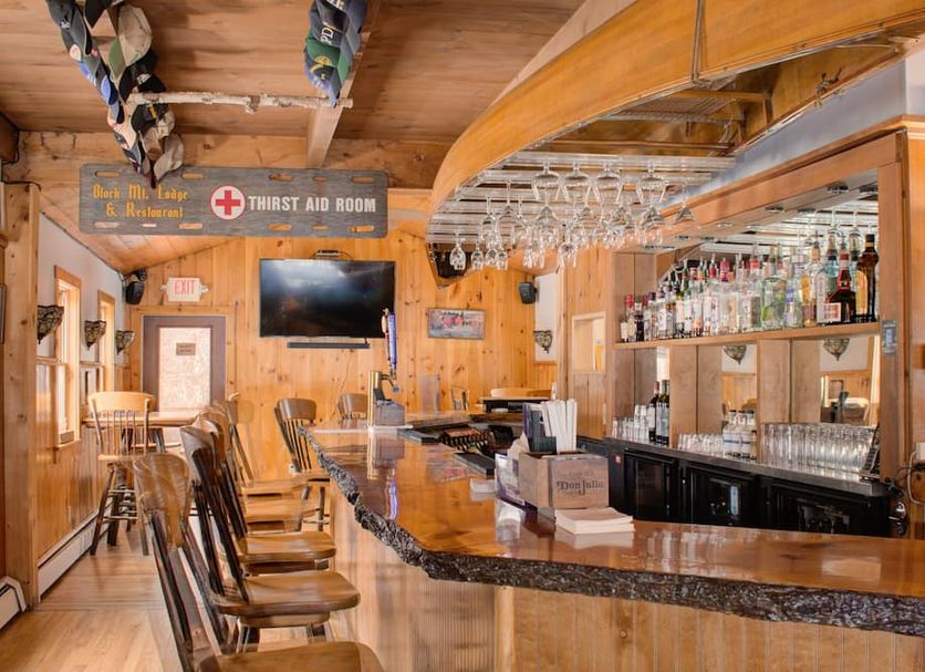 North Creek Lodge at Gore Mountain bar area in North Creek with wooden decor and mounted TV