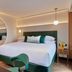 The Chancery Hotel Dublin guest room with king bed, arched mirror, and city view