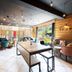 Hotel La Fontaine in Les Houches lounge with wood accents, string lights, seating and mountain views