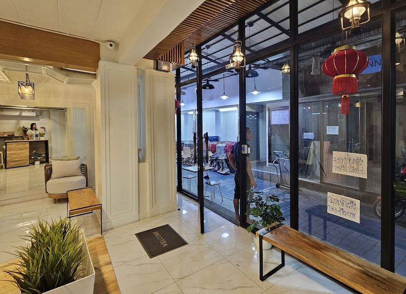 Sleepstation at Pratunam in Bangkok lobby entrance with glass walls and hanging red lanterns