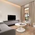 Riva del Sole Resort & Spa in Castiglione della Pescaia living area with sofa, TV, chairs and balcony view