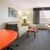 La Quinta Inn & Suites By Wyndham Dfw Airport South / Irving guest room with seating area and window air conditioner