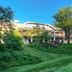 Ashland Hills Hotel & Suites in Ashland surrounded by lush gardens and green lawn under blue sky