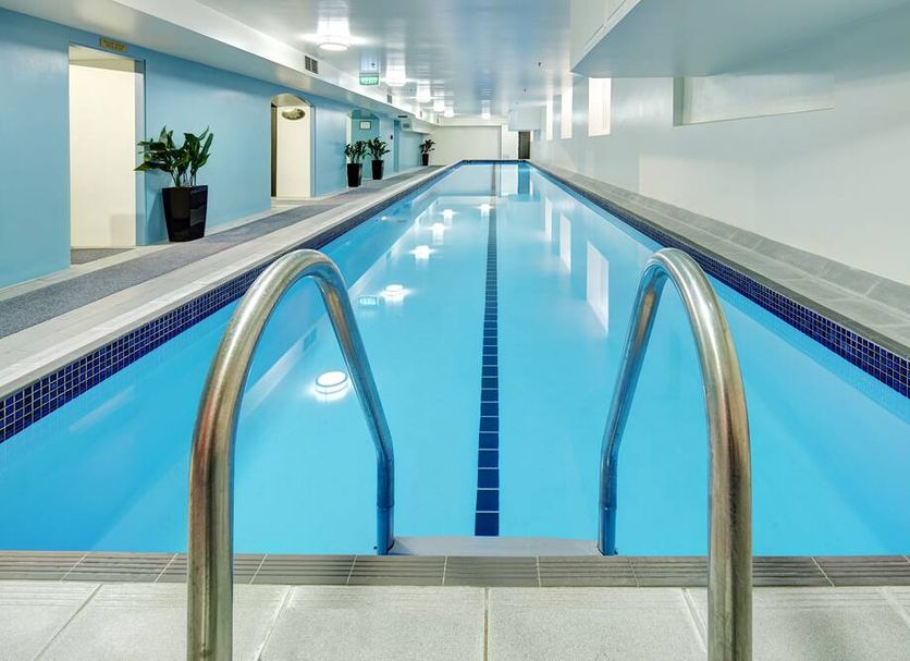 Adina Heritage Christchurch indoor lap pool in Christchurch with calm blue water and stainless steel handrails