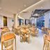 Ji Hotel Shenzhen Shennan Avenue Huaqiang dining area with wooden tables and chairs beside tall windows