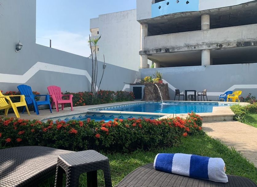 Hotel Jar8 Boca Veracruz outdoor pool with colorful lounge chairs and landscaped seating area