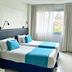 Cyan Recoleta Hotel in Buenos Aires guest room with two twin beds and a window view