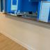 Sea Bay Hotel in Ocean City lobby with blue walls, wood-look floor, and front desk