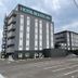 Hotel Route-Inn Saku Minami Inter in Saku, exterior with parking lot and power lines