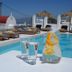 Margie Mykonos Hotel rooftop pool in Mykonos with loungers, umbrellas, and drinks by the water