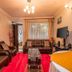 Javilla Eagles Safari Guest House Nairobi living room with leather sofas, TV, glass coffee table and red rug