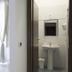 Sfumature Partenopee Naples room with bed, TV, window, and bathroom sink visible