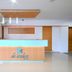 Reception desk at Hotel De Ecobiz in Ahmedabad with modern wood-and-glass lobby interior